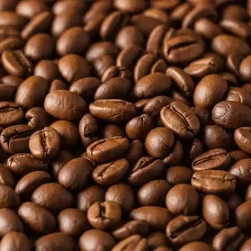 A close-up, full-frame background of a large, dense pile of medium-dark roasted whole coffee beans.